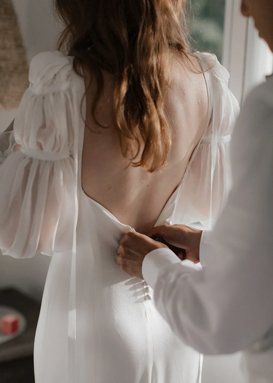Close-up of the open back and buttons of Elyse's white wedding dress. At Fig Tree Villa in Ewingsdale, Byron Bay, for an Elopement Collective elopement. Photograph by Bulb Creative.