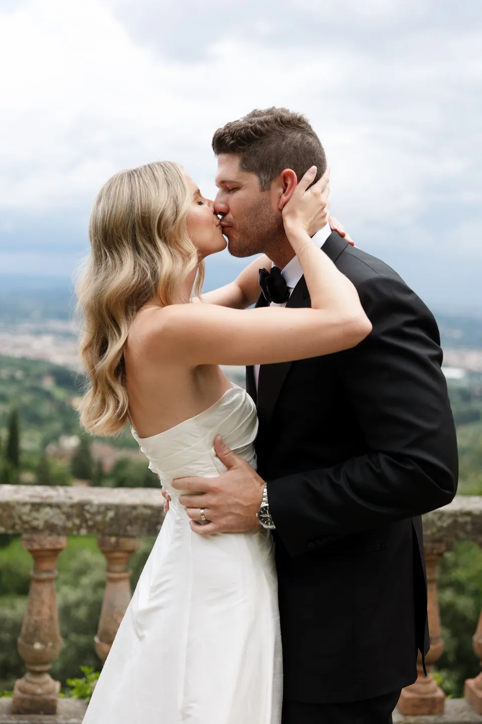 Holly and Matthew kissing after their vows, her hands resting on his face, at Villa San Michele in Fiesole above Florence, Tuscany, Italy, for an Elopement Collective elopement. Digital photograph by Khara from House of Lucie.