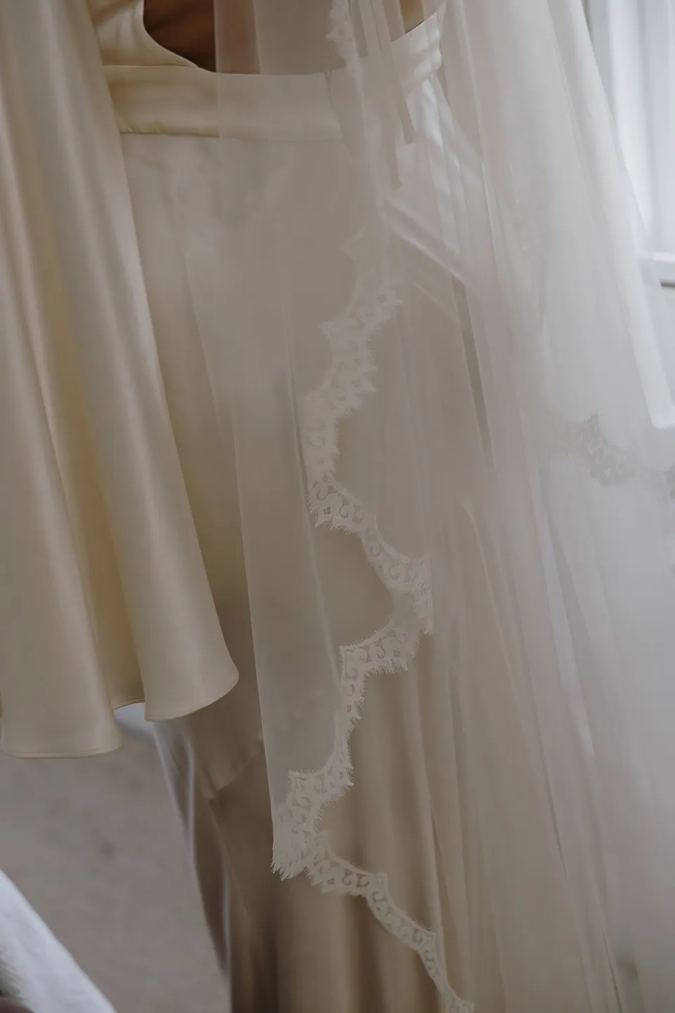 Laura's sheer veil hanging in soft window light. At Fig Tree Villa in Ewingsdale, Byron Bay, for an Elopement Collective elopement. Photograph by George Bowden.