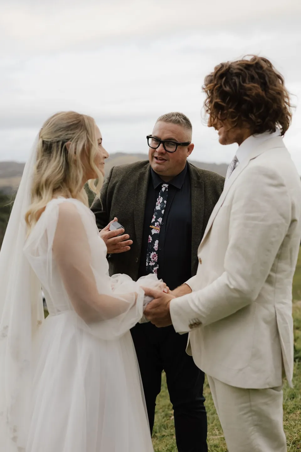 Josh Withers speaking with Bridget and James during their intimate outdoor ceremony. At Cudgera Creek in northern New South Wales, for an Elopement Collective elopement. Photograph by Bulb Creative.