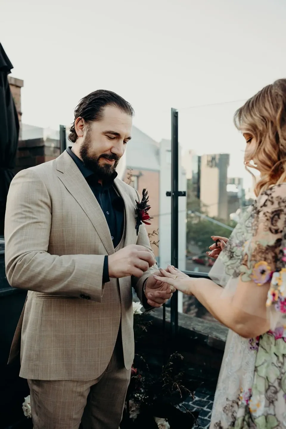 Daniel smiling as he places a wedding ring on Victoria’s finger, at Agnes Restaurant in Fortitude Valley, Brisbane, for an Elopement Collective elopement. Photo by Tessa Shannon.
