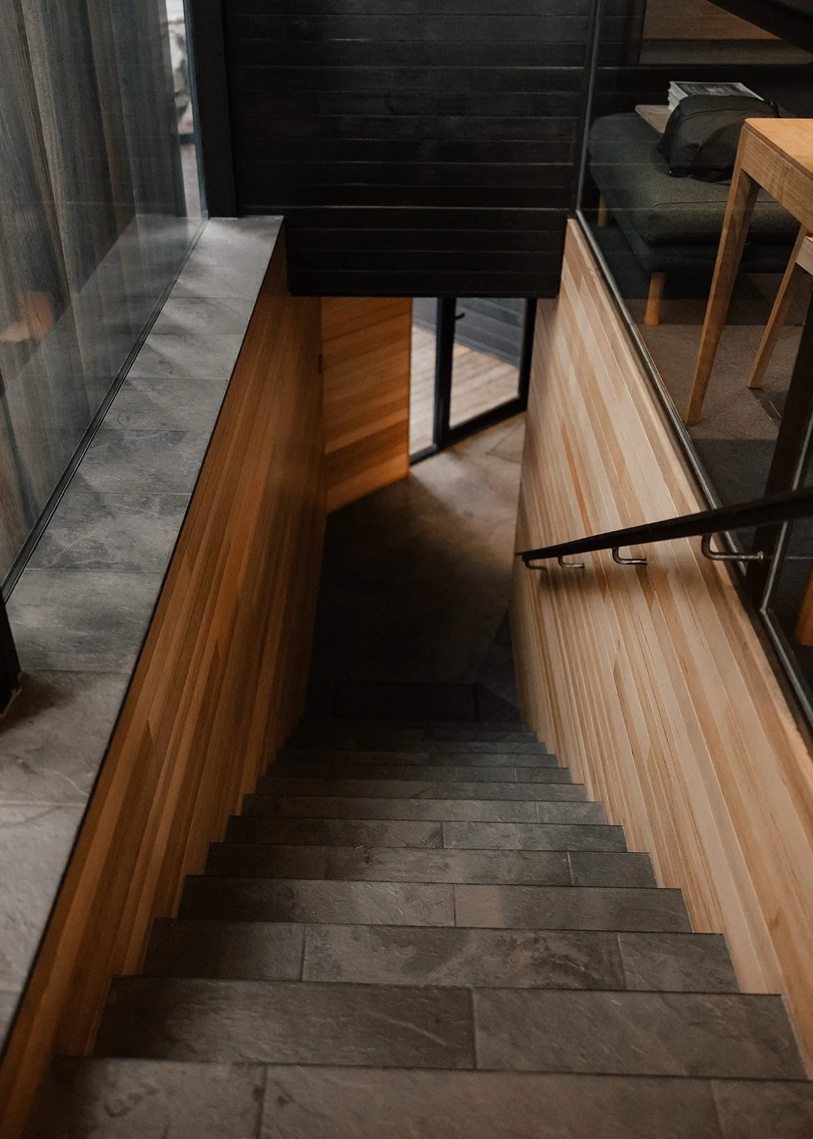 Stone stairs descending between timber walls inside the lakeside accommodation, at Pumphouse Point, Lake St Clair, Tasmania, for an Elopement Collective elopement. Photo by Bulb Creative.